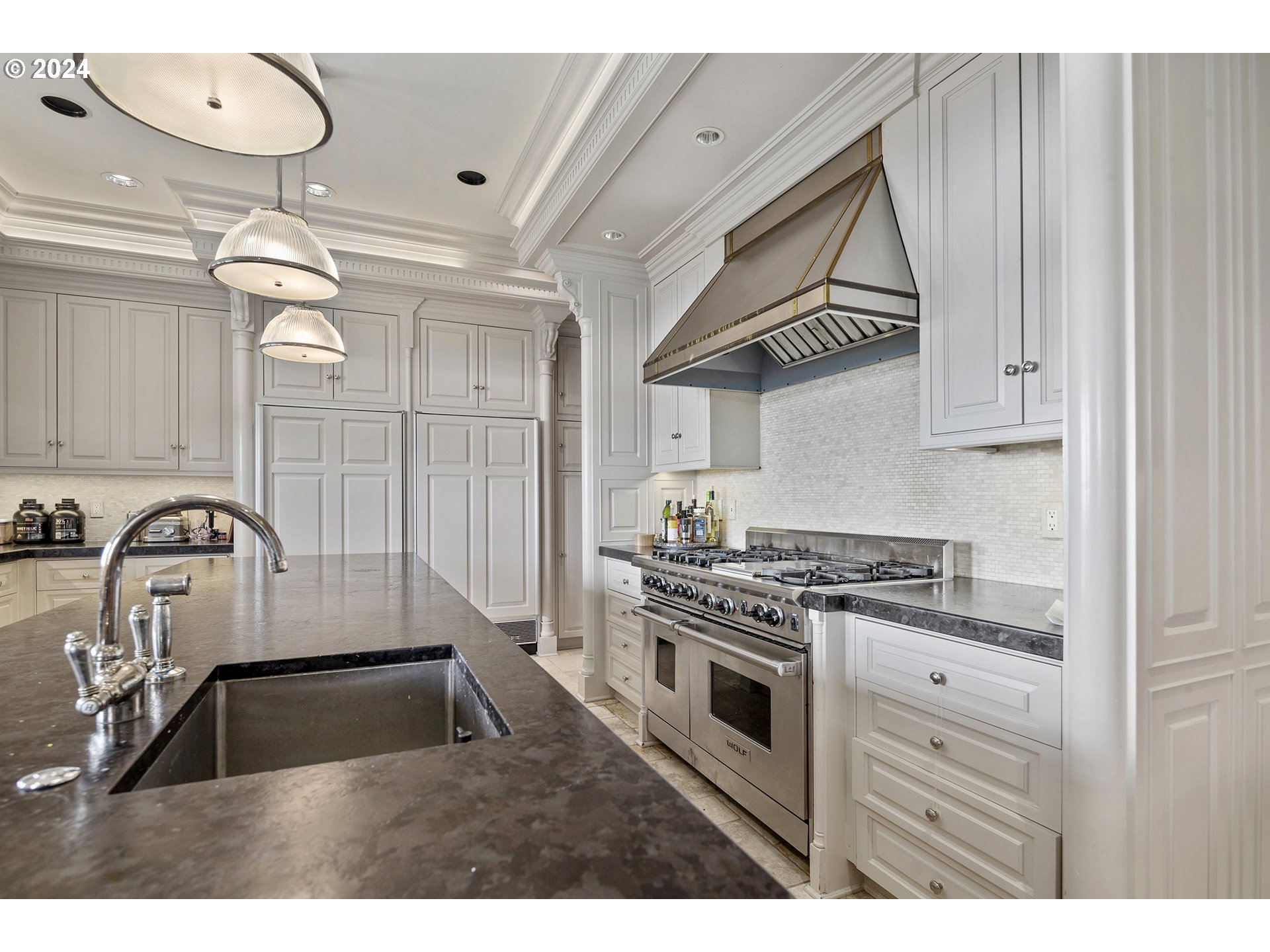 11223 Northwest Saltzman Road Portland, OR 97229 - Photo 20 of 46 a kitchen with kitchen island granite countertop a stove a sink and a microwave