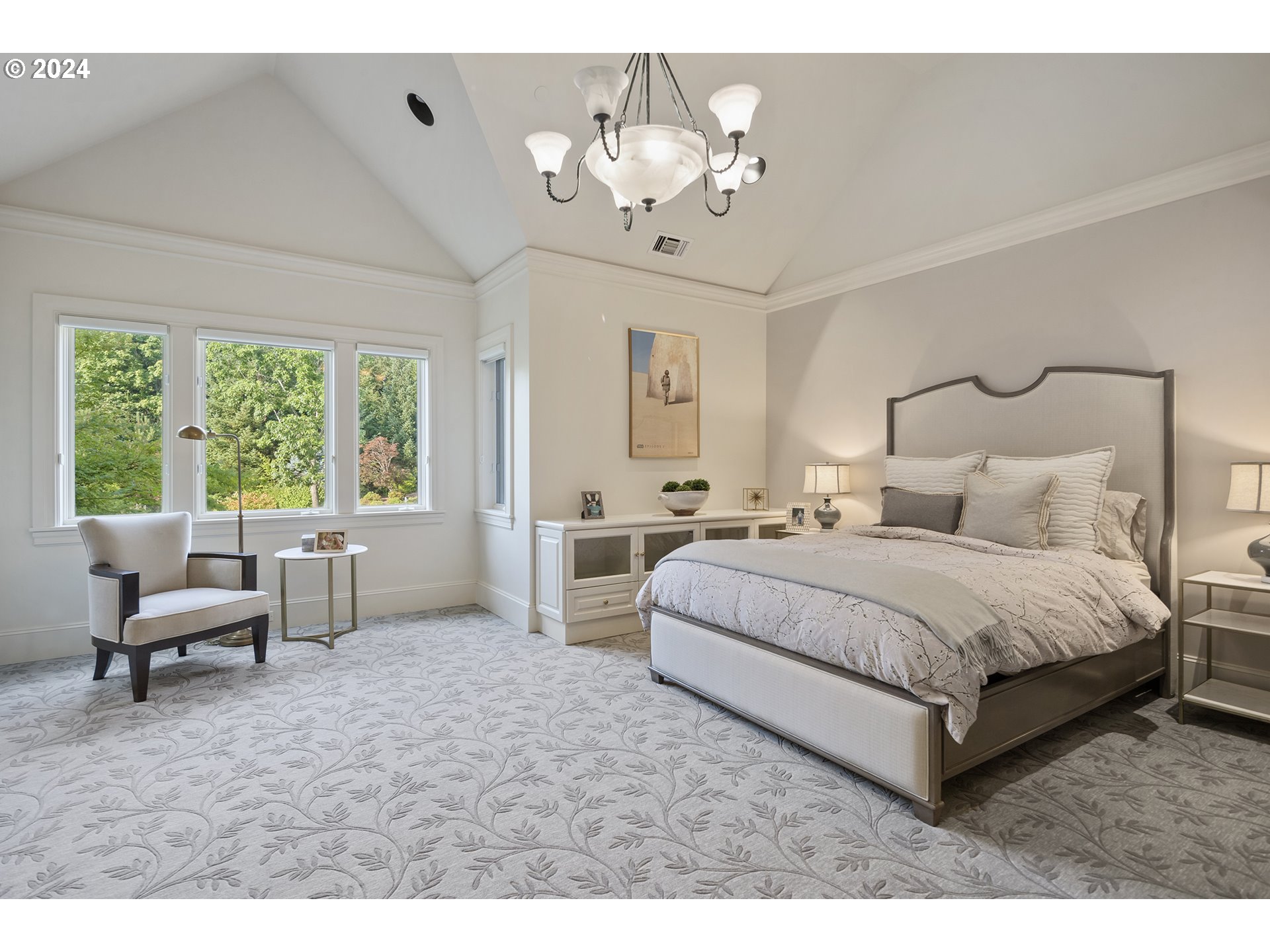 11223 Northwest Saltzman Road Portland, OR 97229 - Photo 33 of 46 a spacious bedroom with a bed and a chandelier