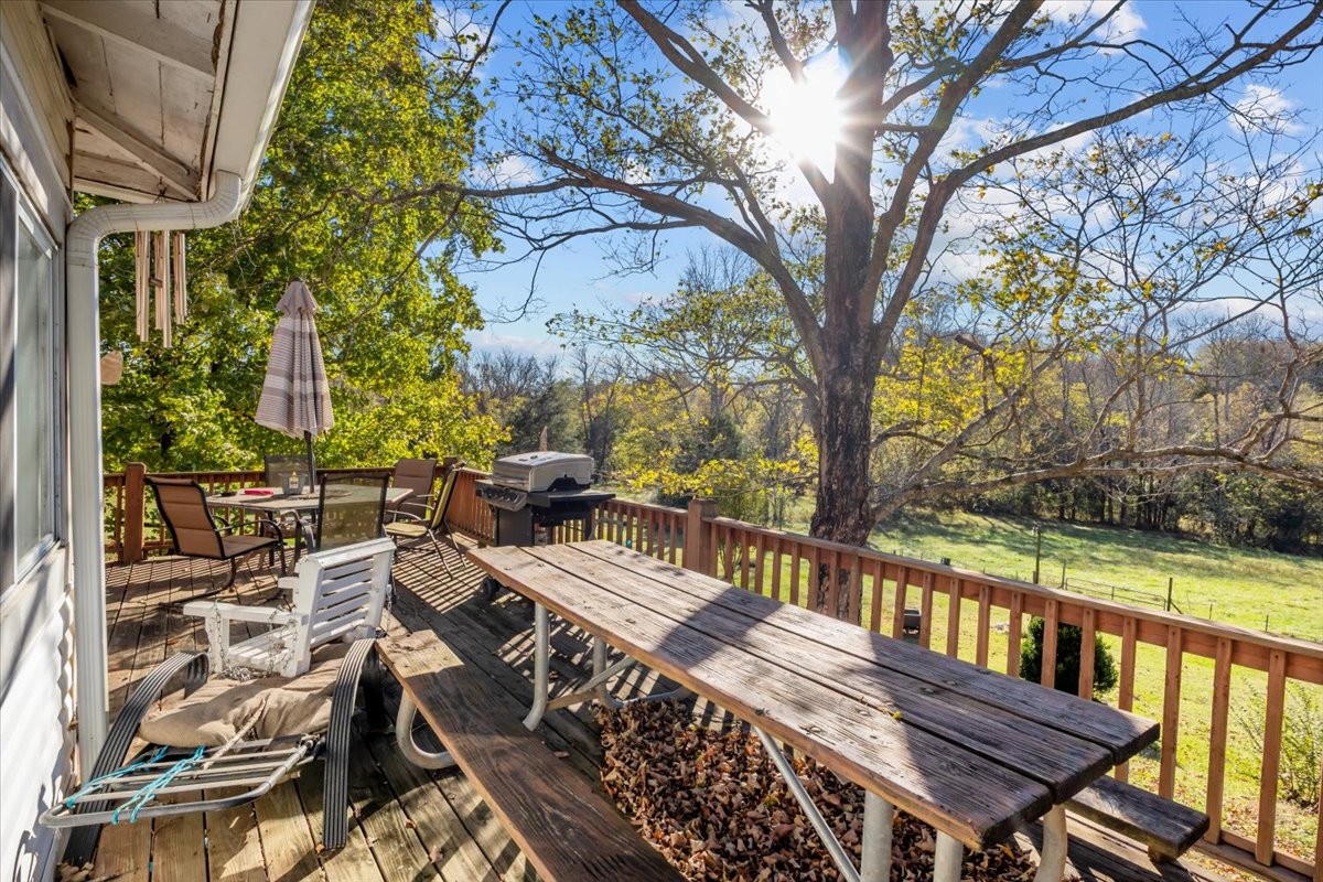 676 Mt Lebanon Road Dickson, TN 37055 - Photo 31 of 74 a view of a balcony with wooden floor and outdoor seating