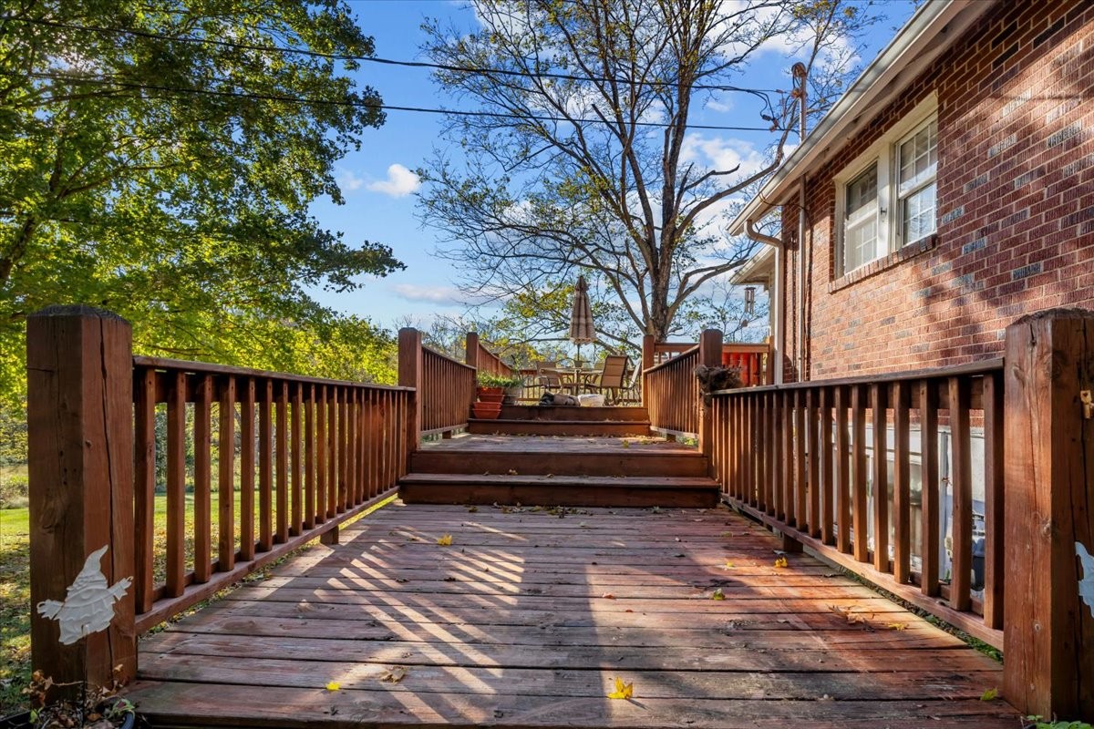 676 Mt Lebanon Road Dickson, TN 37055 - Photo 32 of 74 a view of a house with a wooden deck and a large tree