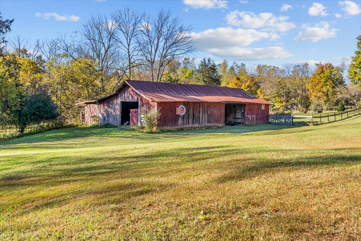 676 Mt Lebanon Road Dickson, TN 37055 - Photo 37 of 74 a view of a house with a big yard and palm trees