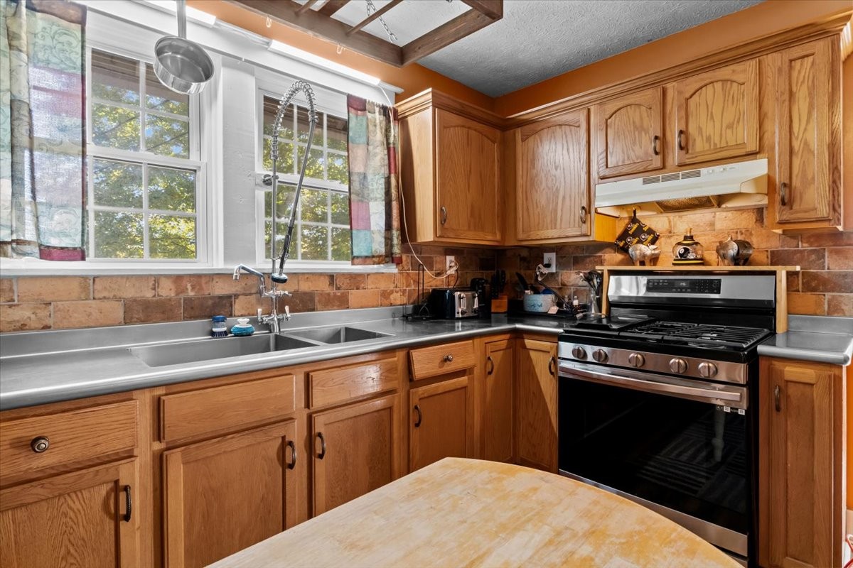 676 Mt Lebanon Road Dickson, TN 37055 - Photo 10 of 74 a kitchen with stainless steel appliances granite countertop a sink a stove and cabinets