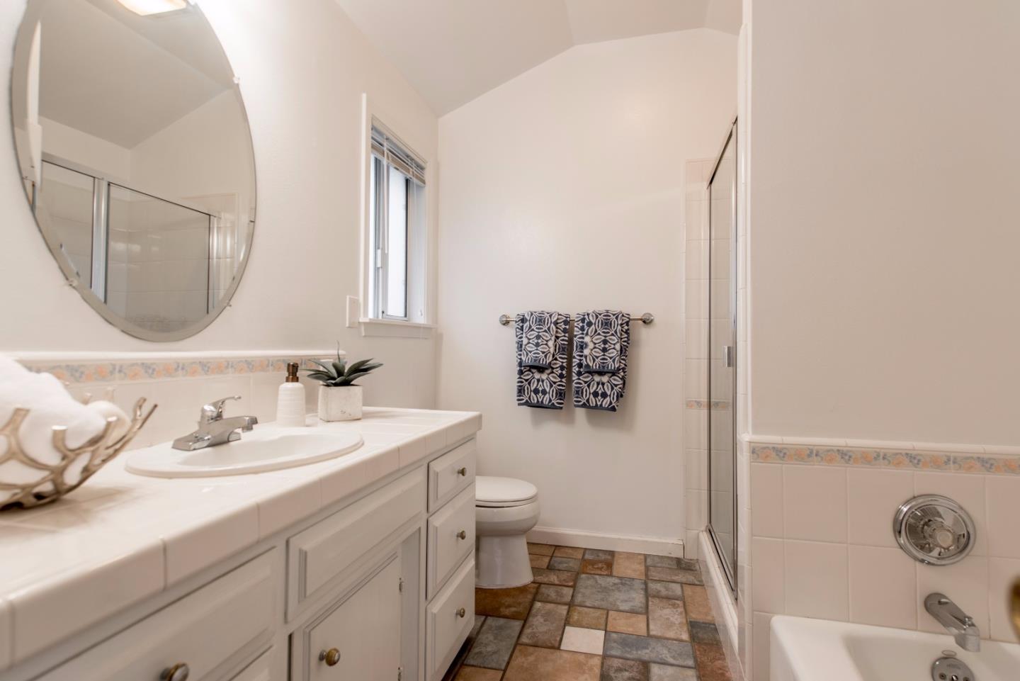 1003 Mango Avenue Sunnyvale, CA 94087 - Photo 12 of 23 a bathroom with a sink a toilet and a mirror