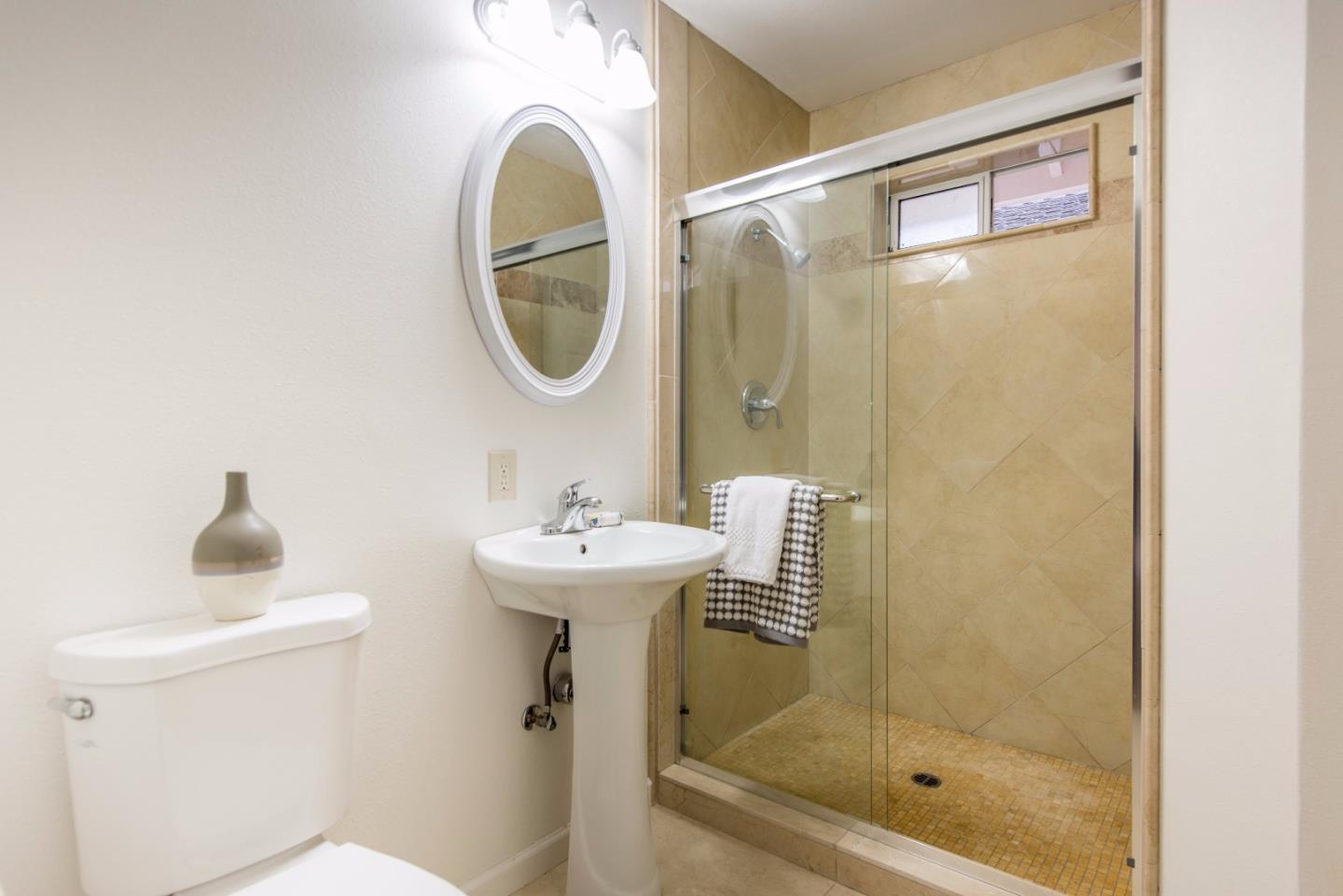 1003 Mango Avenue Sunnyvale, CA 94087 - Photo 17 of 23 a bathroom with a sink a mirror and a shower