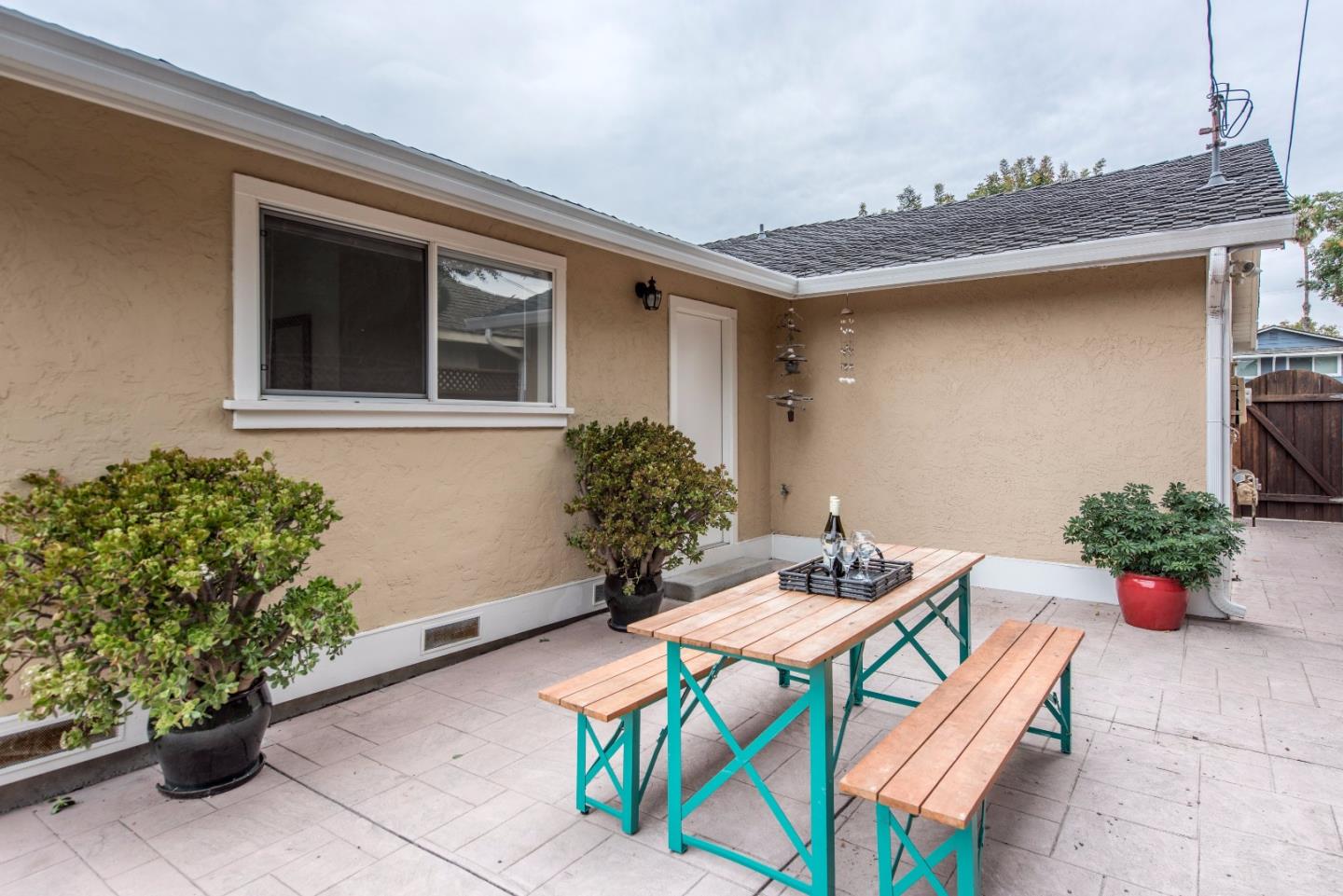 1003 Mango Avenue Sunnyvale, CA 94087 - Photo 19 of 23 a table and chairs in front of a house