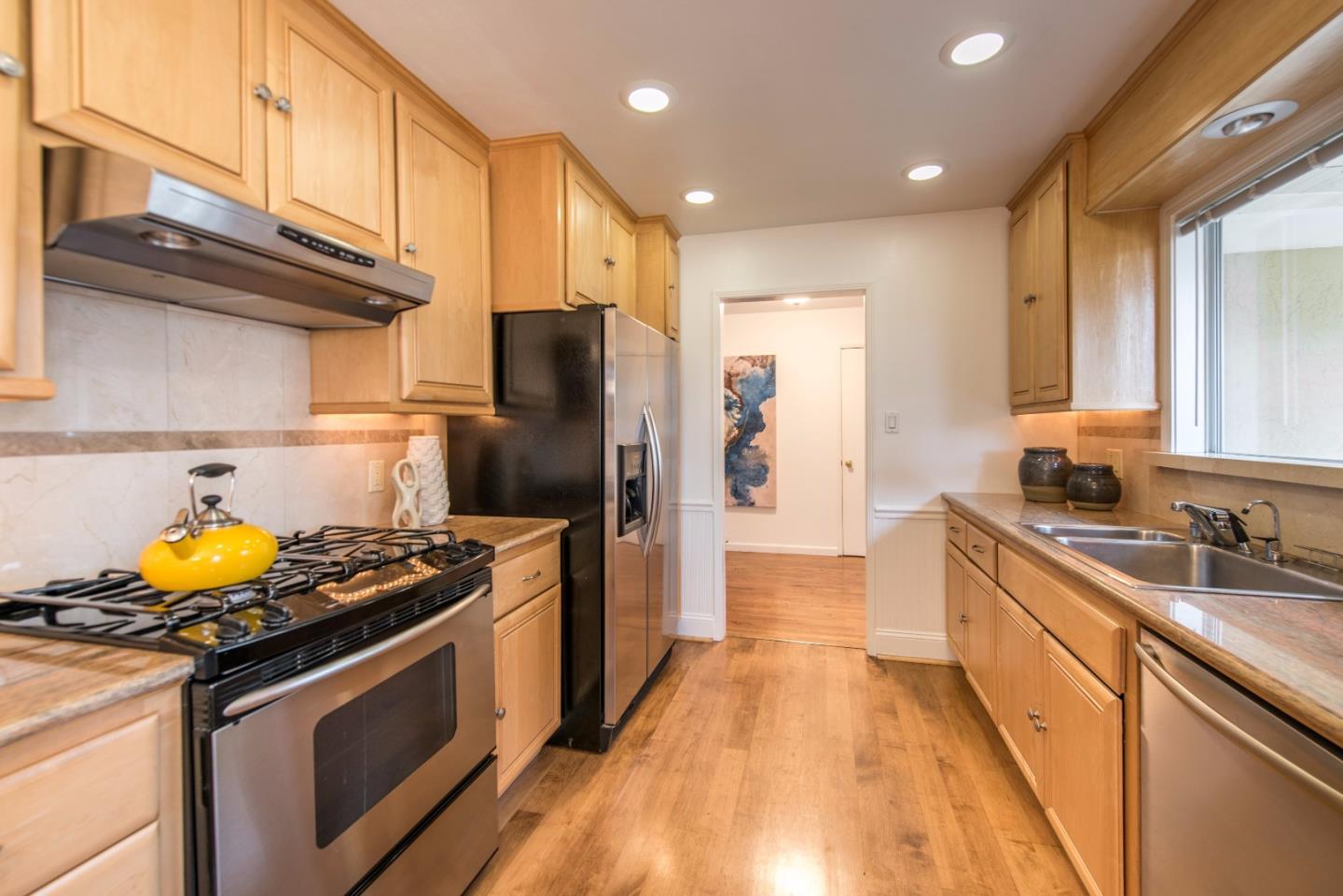1003 Mango Avenue Sunnyvale, CA 94087 - Photo 8 of 23 a kitchen with stainless steel appliances granite countertop a stove a refrigerator and a sink
