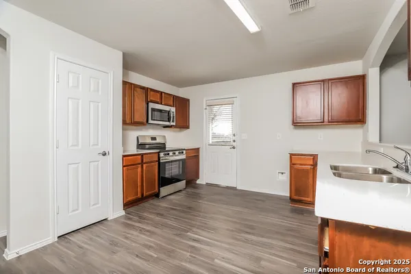 a kitchen with stainless steel appliances granite countertop a sink stove and refrigerator