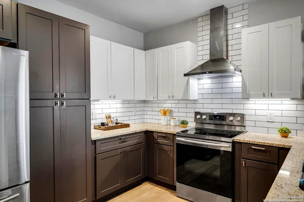 a kitchen with a sink stove and cabinets