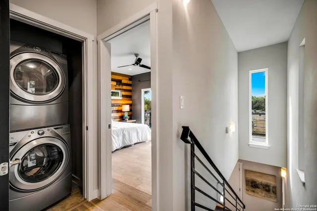 a view of a hallway with washer and dryer