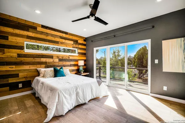 a bedroom with a large bed and a large window