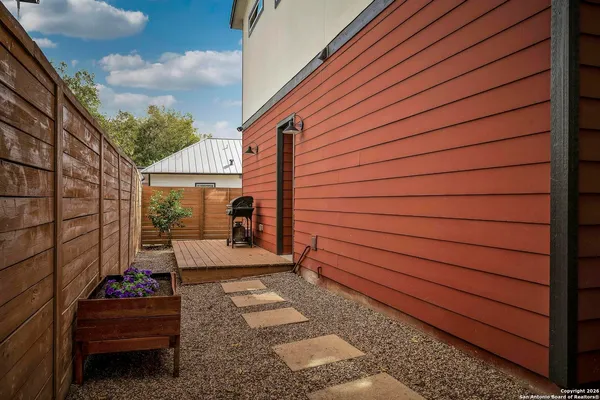 a view of a house with backyard and sitting area