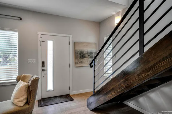 a view of entryway with wooden floor and stairs