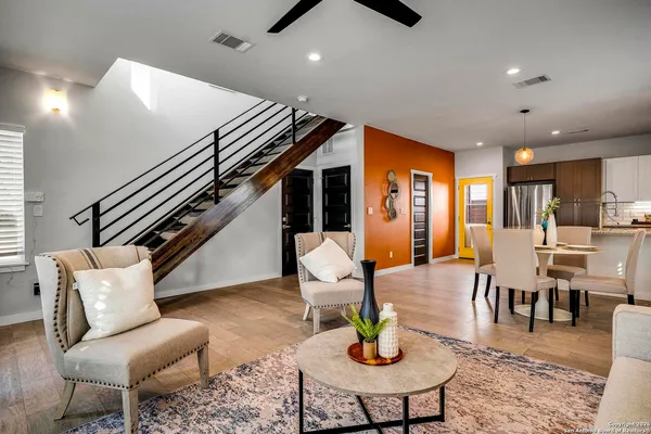a living room with furniture and wooden floor