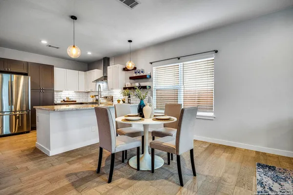 a view of a dining room with furniture window and wooden floor
