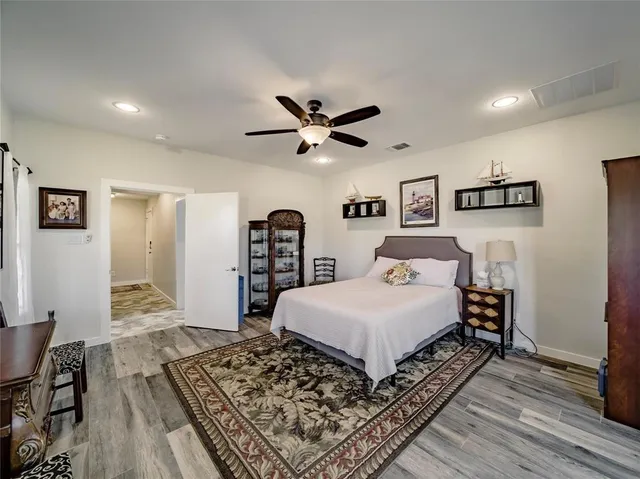 a bedroom with bed and wooden floor