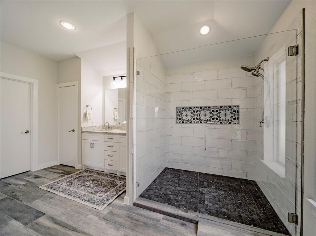 2107 Countryside Drive Denton, TX 76208 - Photo 18 of 40 a bathroom with a sink and a shower