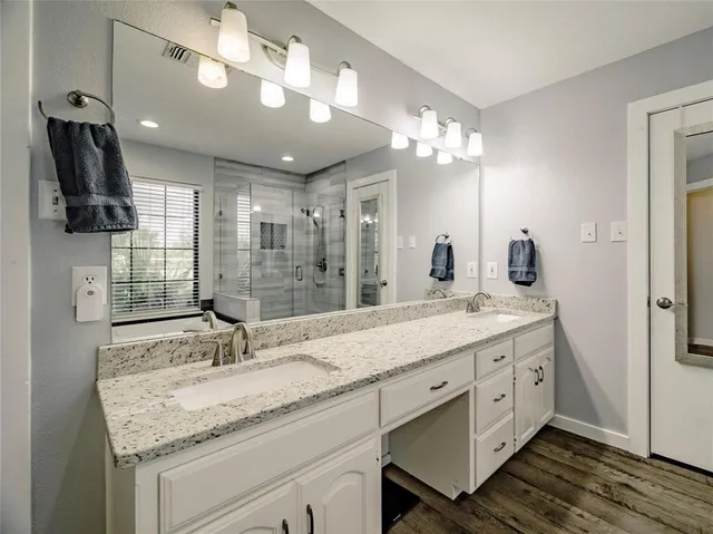 a bathroom with a sink double vanity and a mirror