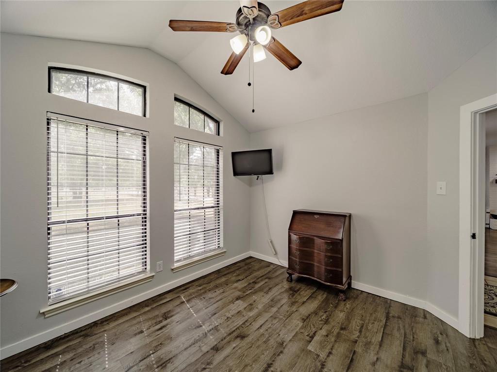 2107 Countryside Drive Denton, TX 76208 - Photo 23 of 40 a view of an empty room with wooden floor and a window