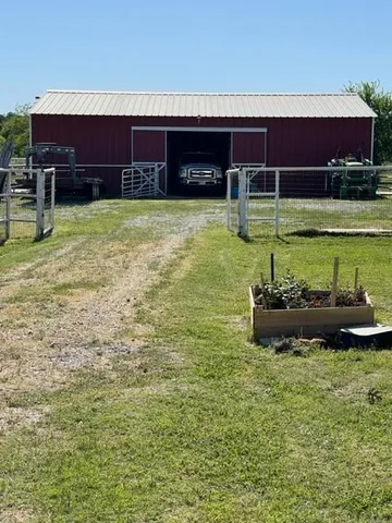a view of a house with swimming pool and a yard