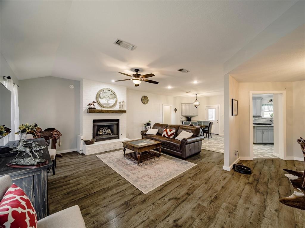 2107 Countryside Drive Denton, TX 76208 - Photo 5 of 40 a living room with furniture and a fireplace