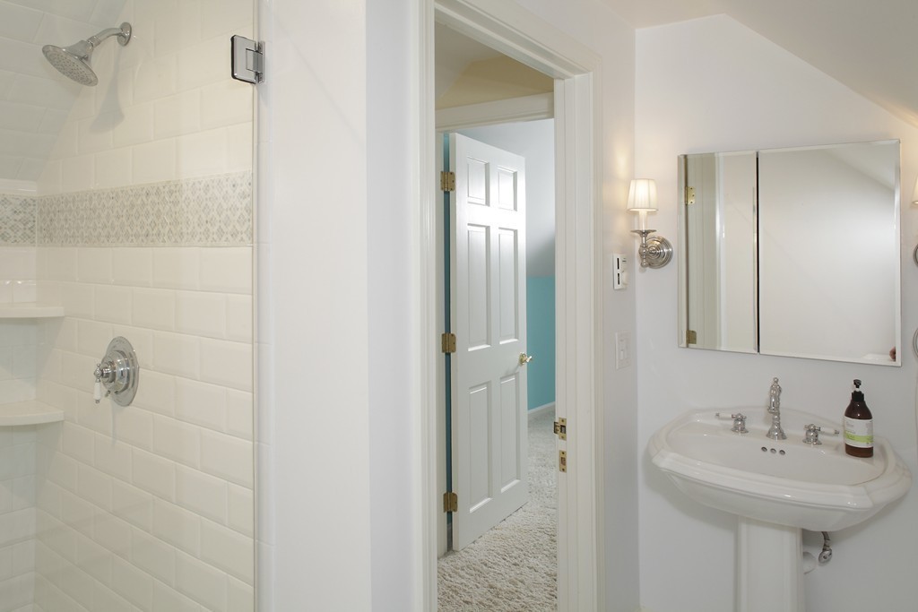 74 Branch Street, Unit 3 Scituate, MA 02066 - Photo 15 of 21 a bathroom with a sink a mirror and shower