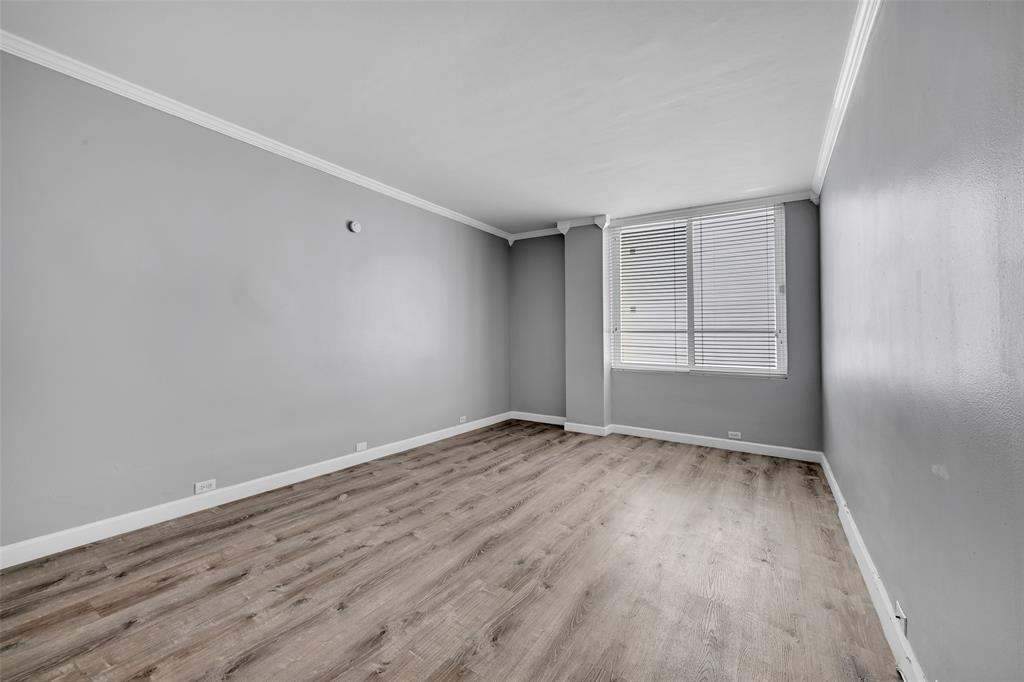 5005 Collins Avenue, Unit PH6 Miami Beach, FL 33140 - Photo 15 of 34 an empty room with wooden floor and windows