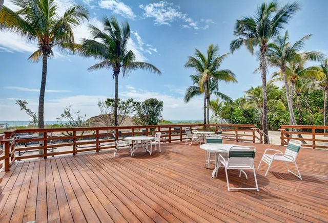 a view of a roof deck with a table and chairs