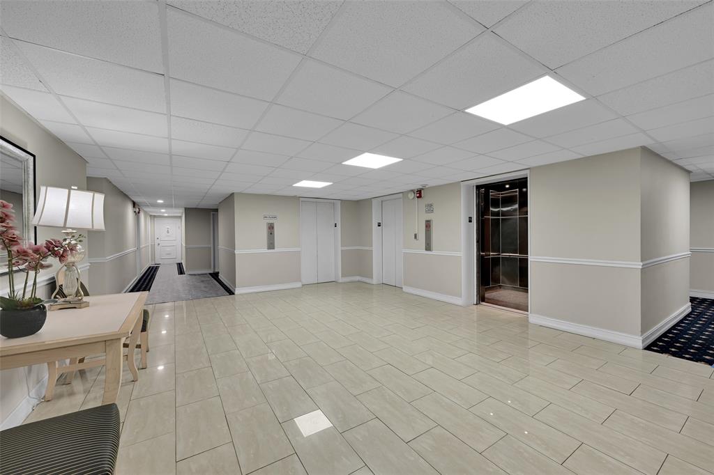 5005 Collins Avenue, Unit PH6 Miami Beach, FL 33140 - Photo 20 of 34 a view of a livingroom with furniture & cabinets