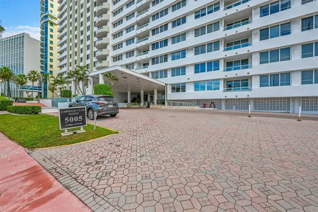 a front view of a building with a garden