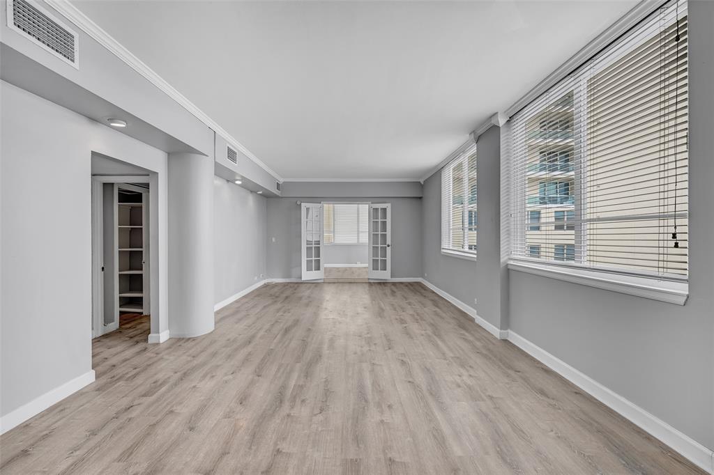 5005 Collins Avenue, Unit PH6 Miami Beach, FL 33140 - Photo 3 of 34 a view of an empty room with wooden floor and a window