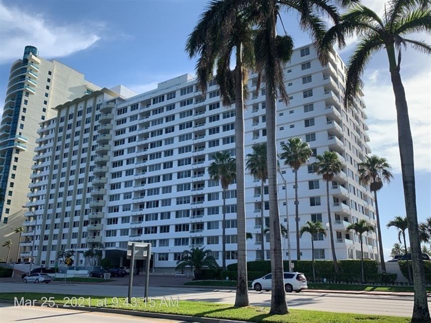 5005 Collins Avenue, Unit PH6 Miami Beach, FL 33140 - Photo 32 of 34 a view of a building with a palm trees