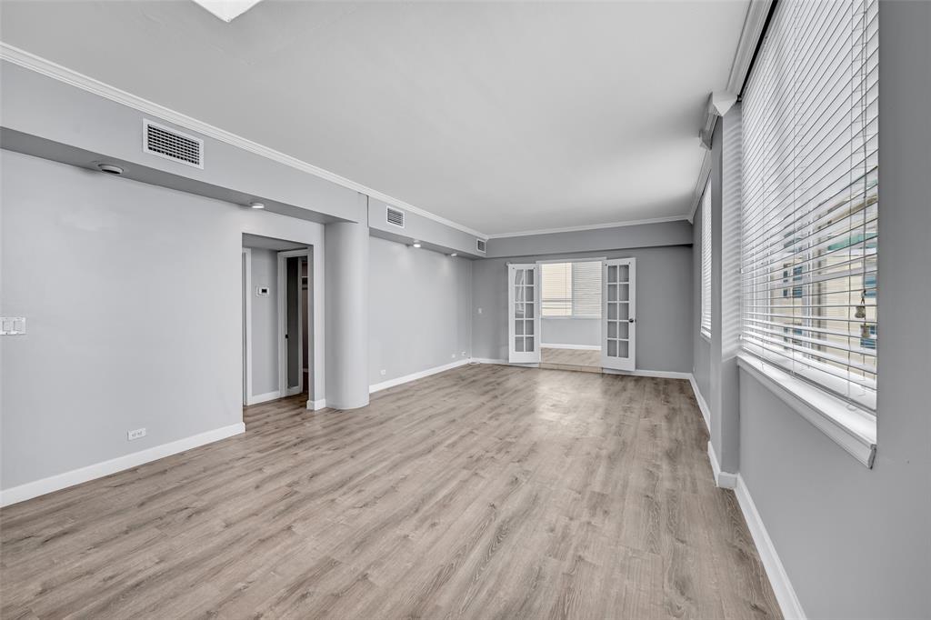 5005 Collins Avenue, Unit PH6 Miami Beach, FL 33140 - Photo 4 of 34 a view of an empty room with wooden floor and a window