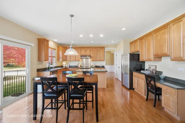 a living room with furniture fireplace and kitchen view