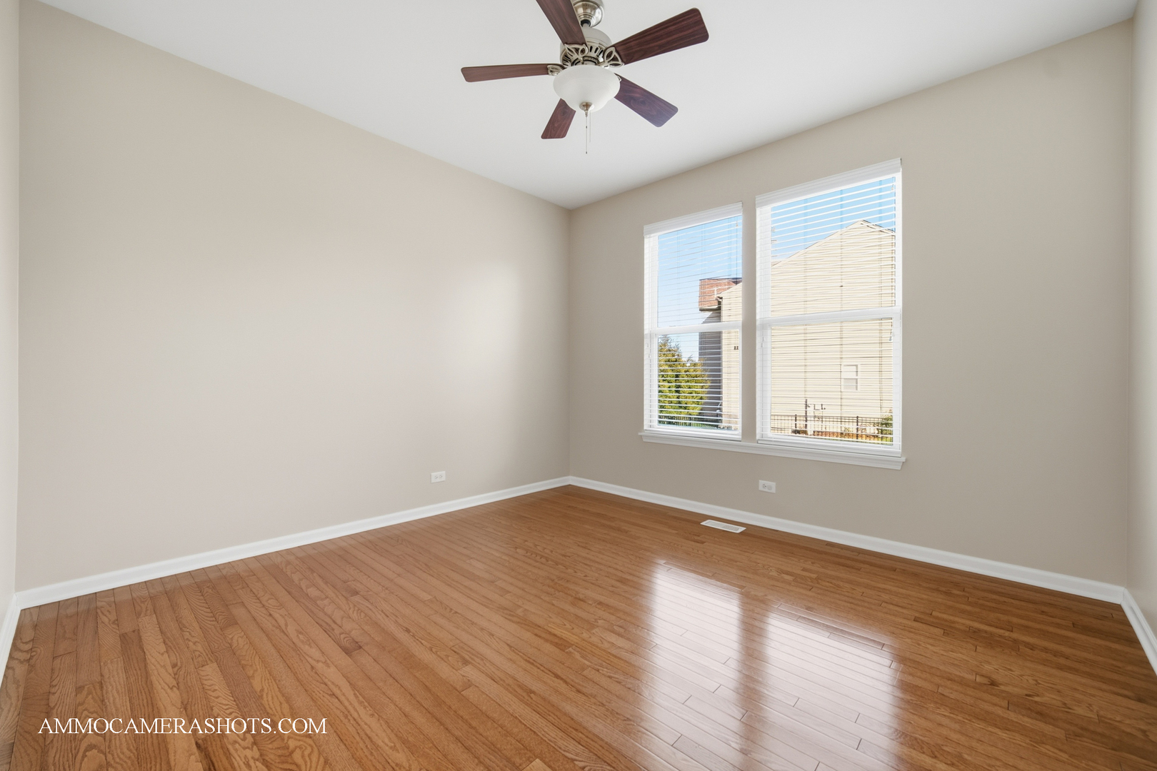 1329 Turnberry Lane Mundelein, IL 60060 - Photo 18 of 33 an empty room with wooden floor chandelier fan and windows
