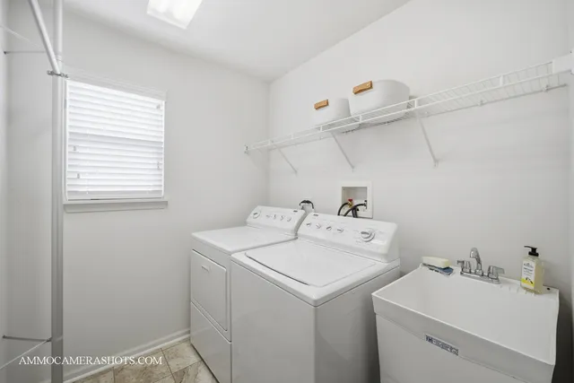 a view of an empty room with wooden floor and staircase