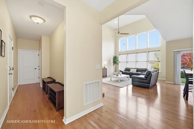 a living room with fireplace furniture and a large window