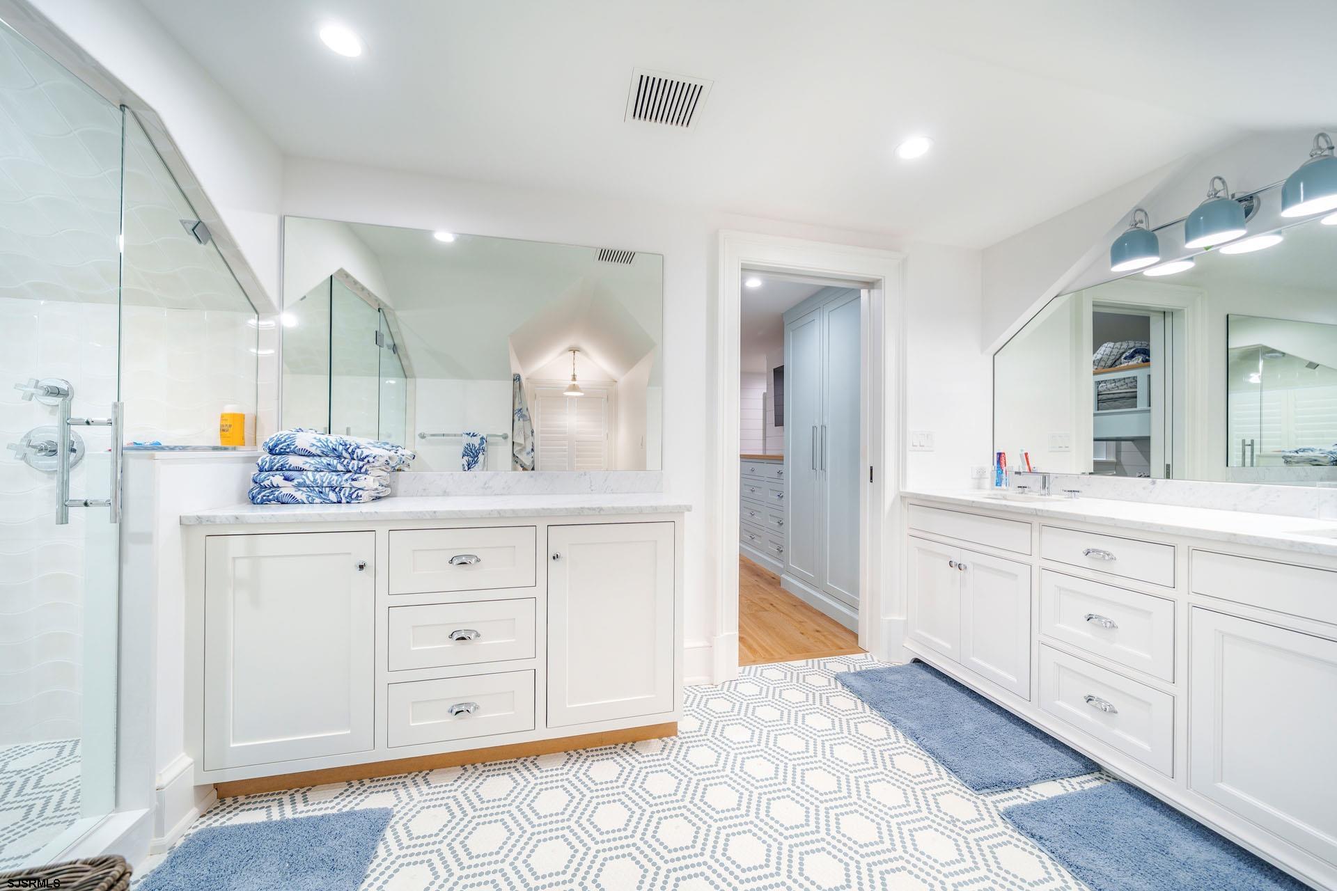 55 Walnut Road Ocean City, NJ 08226 - Photo 66 of 97 a spacious bathroom with a granite countertop sink mirror and cabinets