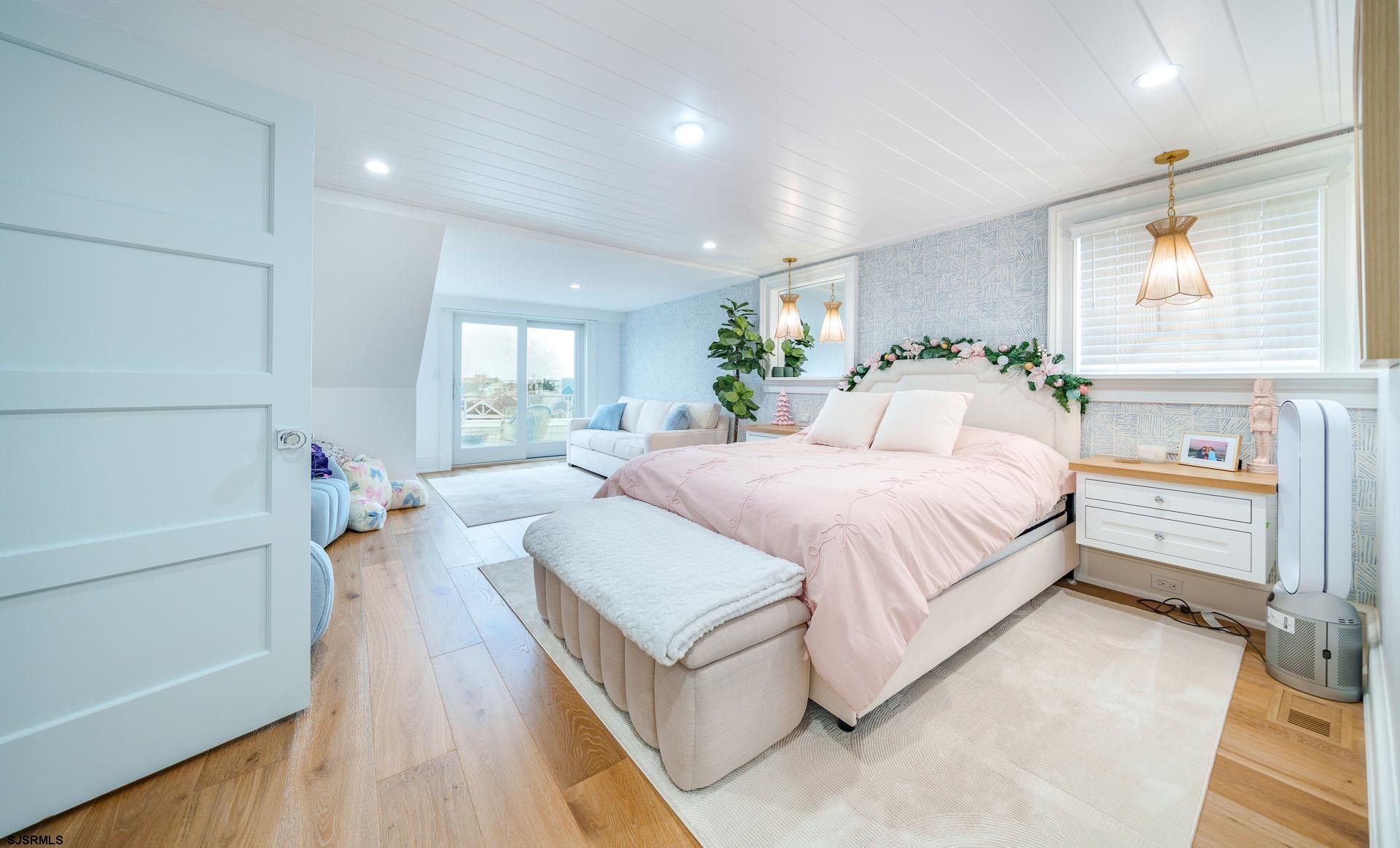 55 Walnut Road Ocean City, NJ 08226 - Photo 67 of 97 a spacious bedroom with a bed and a wooden floor