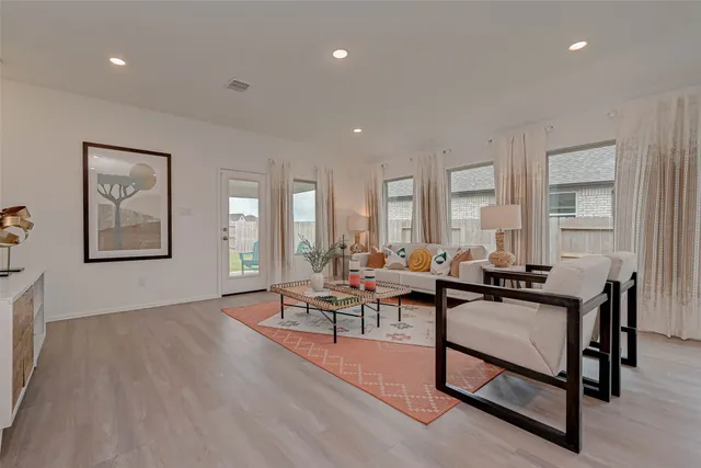 a living room with furniture a window and a table