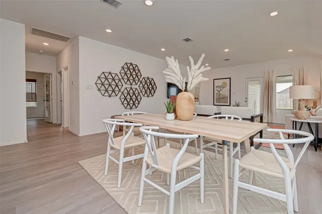 a view of a dining room with furniture and wooden floor