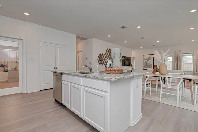 a kitchen with center island table and chairs