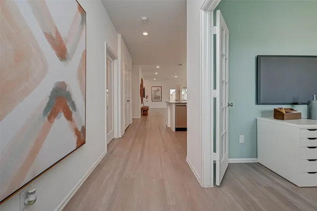 a view of a hallway with wooden floor