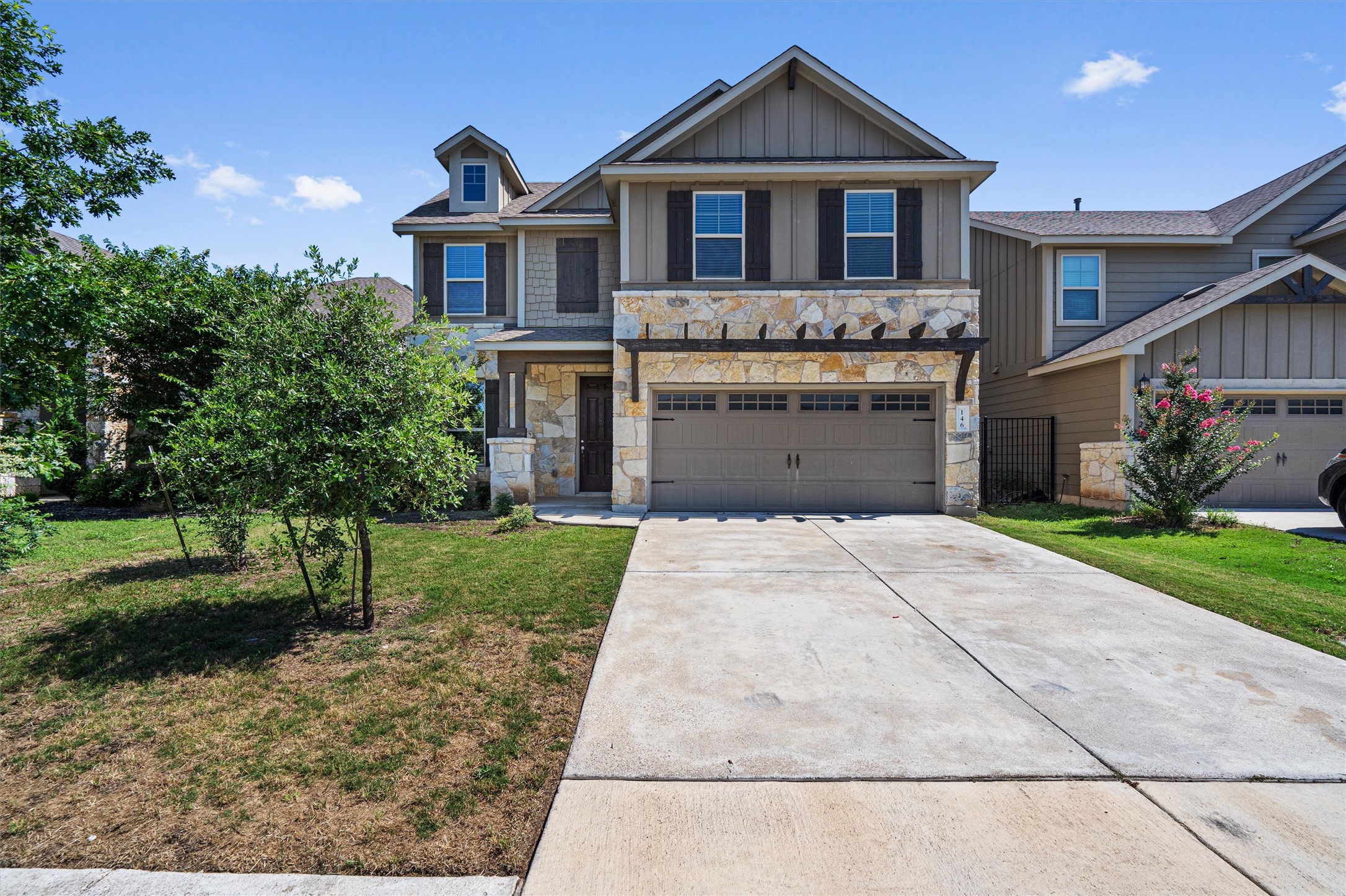 a front view of a house with a yard and garage