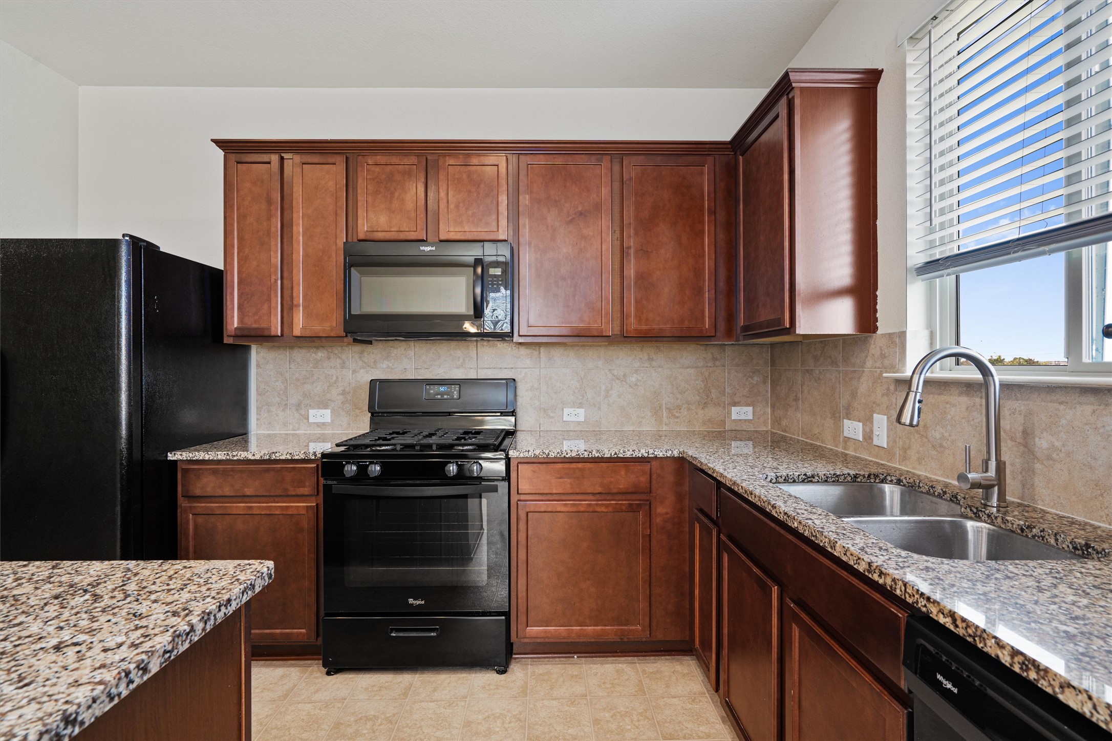146 Russet Trail Georgetown, TX 78628 - Photo 11 of 37 a kitchen with granite countertop a stove sink and cabinets