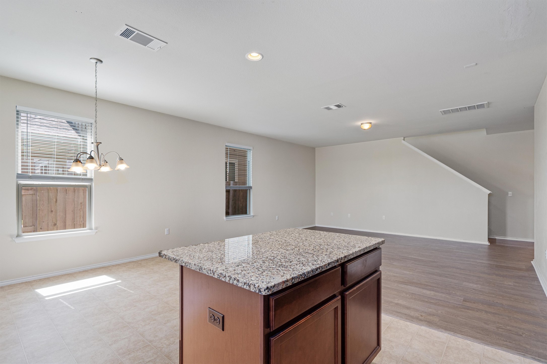 146 Russet Trail Georgetown, TX 78628 - Photo 14 of 37 a kitchen with a kitchen island white cabinets and wooden floor