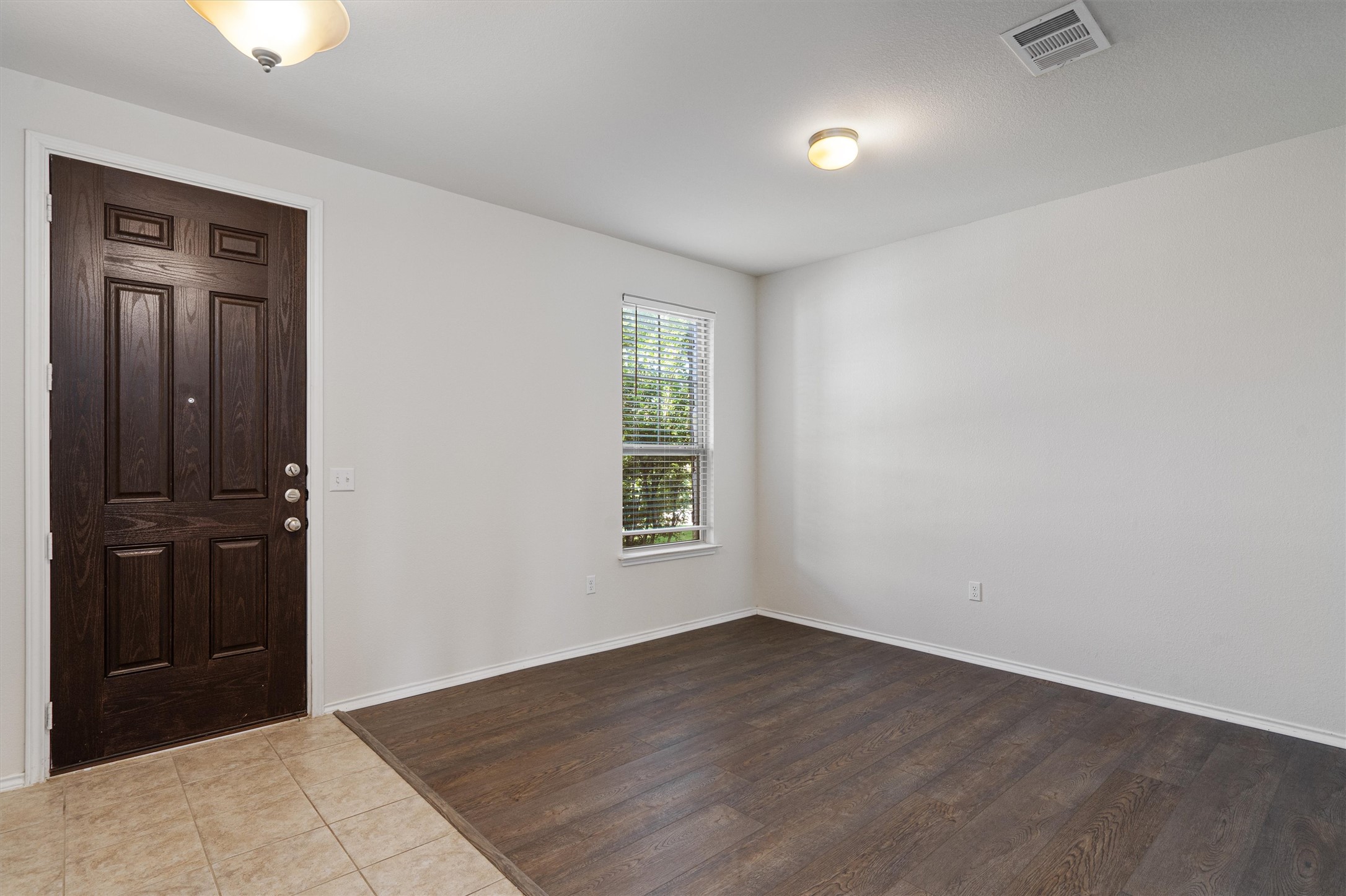 146 Russet Trail Georgetown, TX 78628 - Photo 4 of 37 an empty room with wooden floor closet and windows
