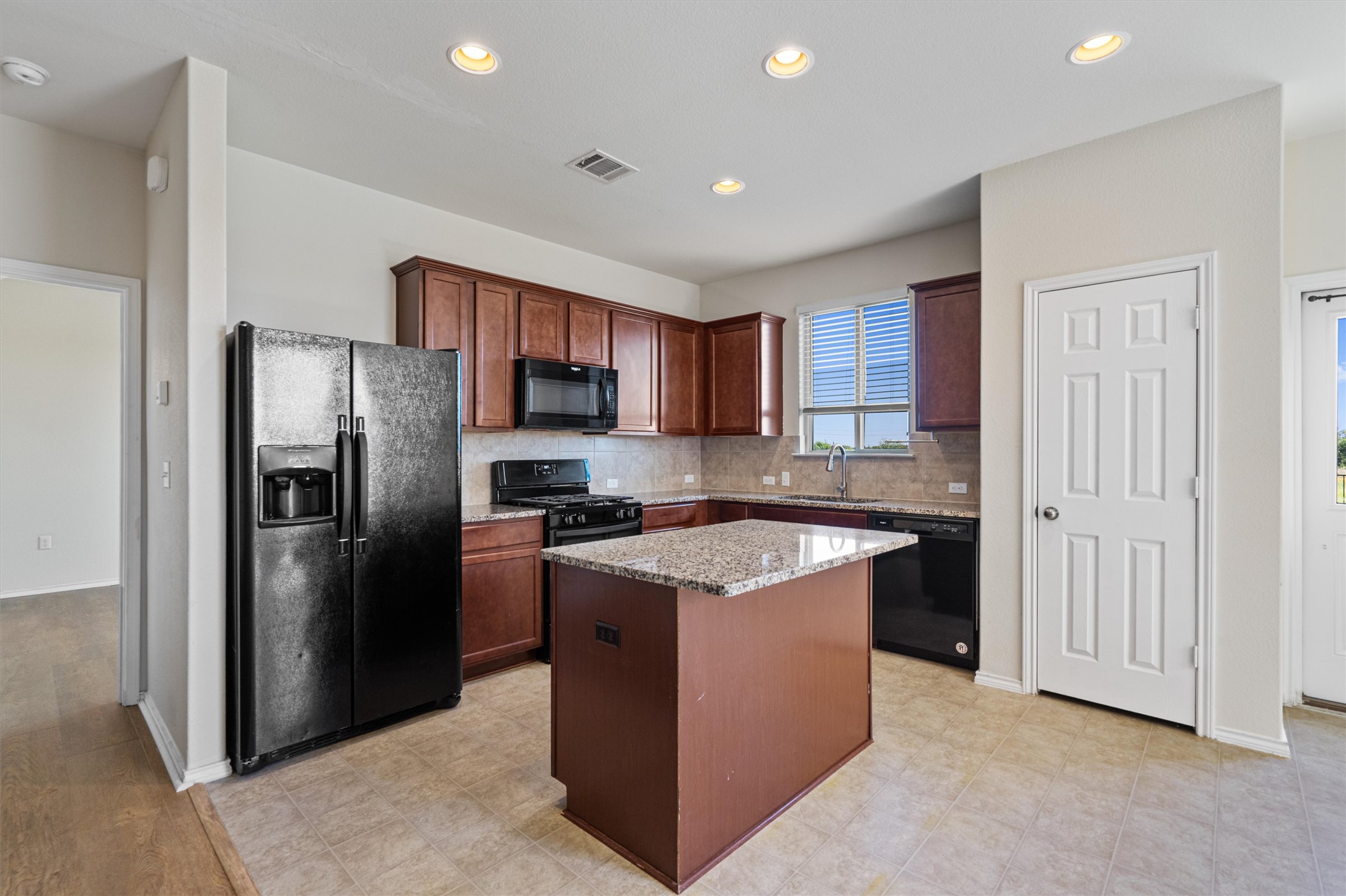 146 Russet Trail Georgetown, TX 78628 - Photo 10 of 37 a kitchen with stainless steel appliances granite countertop a stove top oven a refrigerator and a sink