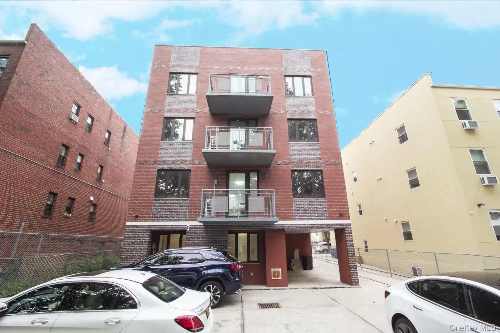 108-38 41st Avenue, Unit 4A Queens, NY 11368 - Photo 2 of 10 a front view of a building with parking space