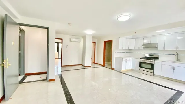 a kitchen with stainless steel appliances a refrigerator and a stove top oven