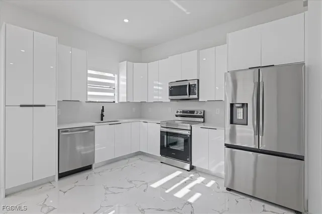 a kitchen with a refrigerator sink and microwave